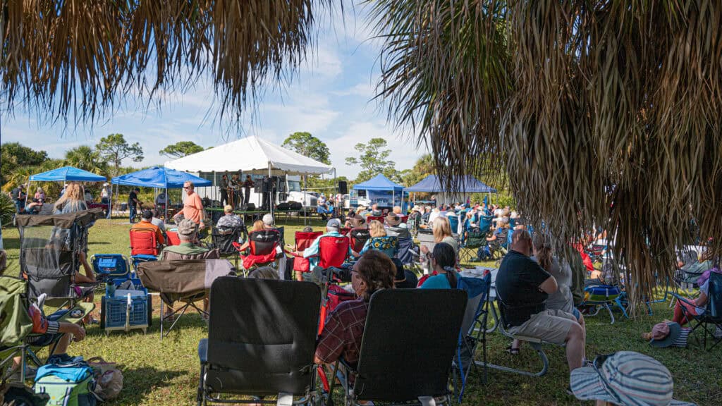 a group of people enjoy a music festival at a state park