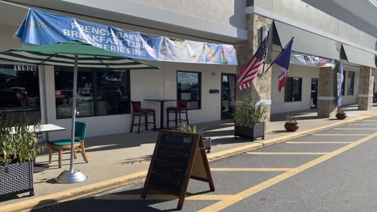 strip mall with a chalkboard sign out front