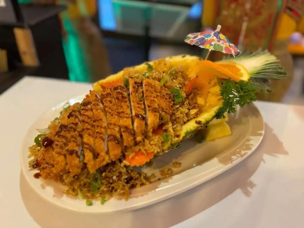 fish on a pineapple with a bed of rice