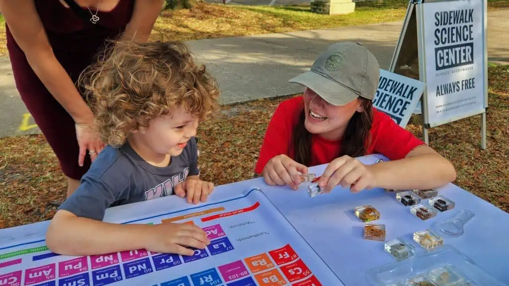 child with periodic table of elements.