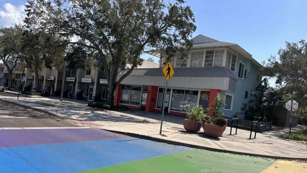 Outside a restaurant with a rainbow street mural