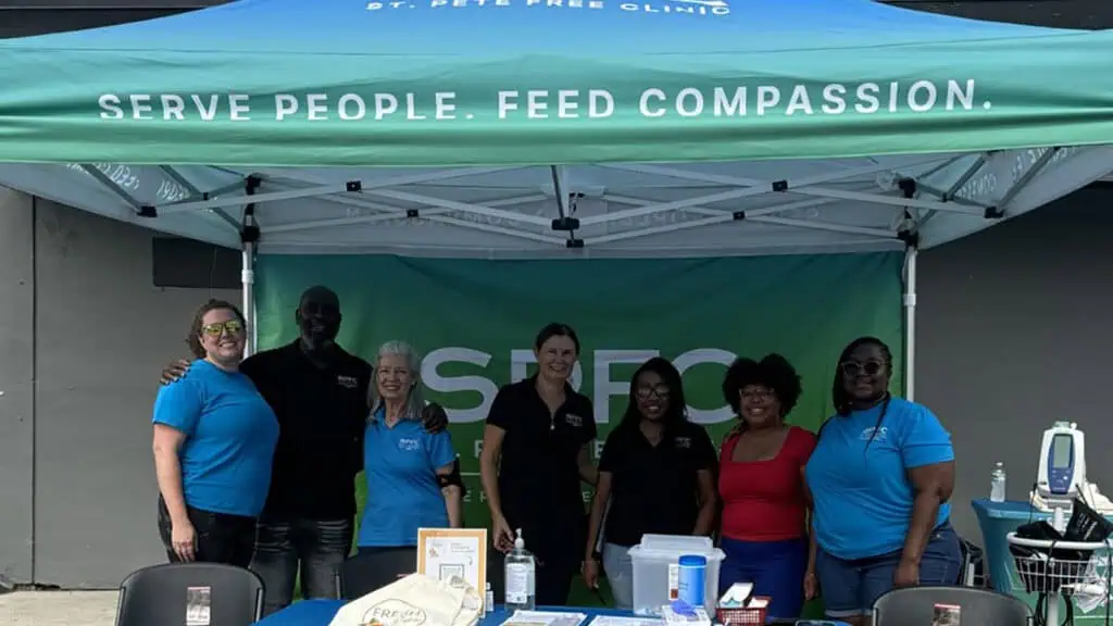 people under a blue and green tent