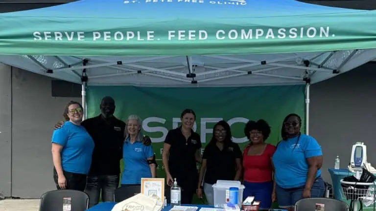 people under a blue and green tent