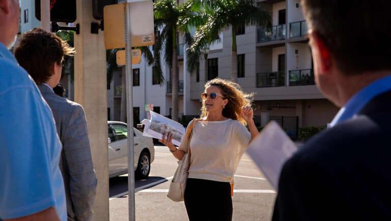 Monica Kile gesturing while on a walking tour on Second Avenue.