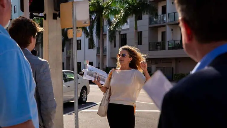 Monica Kile gesturing while on a walking tour on Second Avenue.