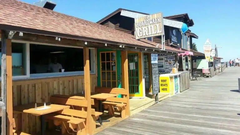 boardwalk with wooden building and tables