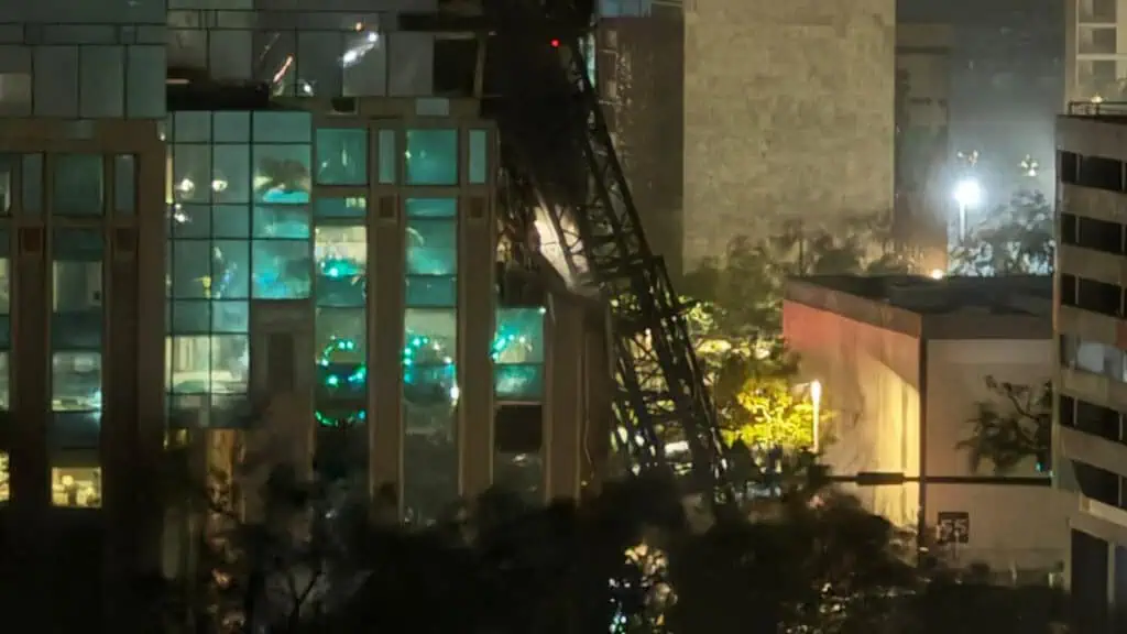 a crane topples into a building