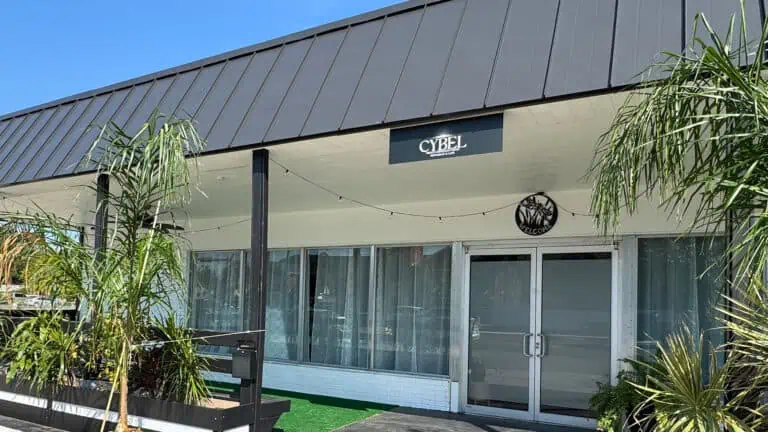 Cybel Restaurant's facade and entry door with plants on the patio