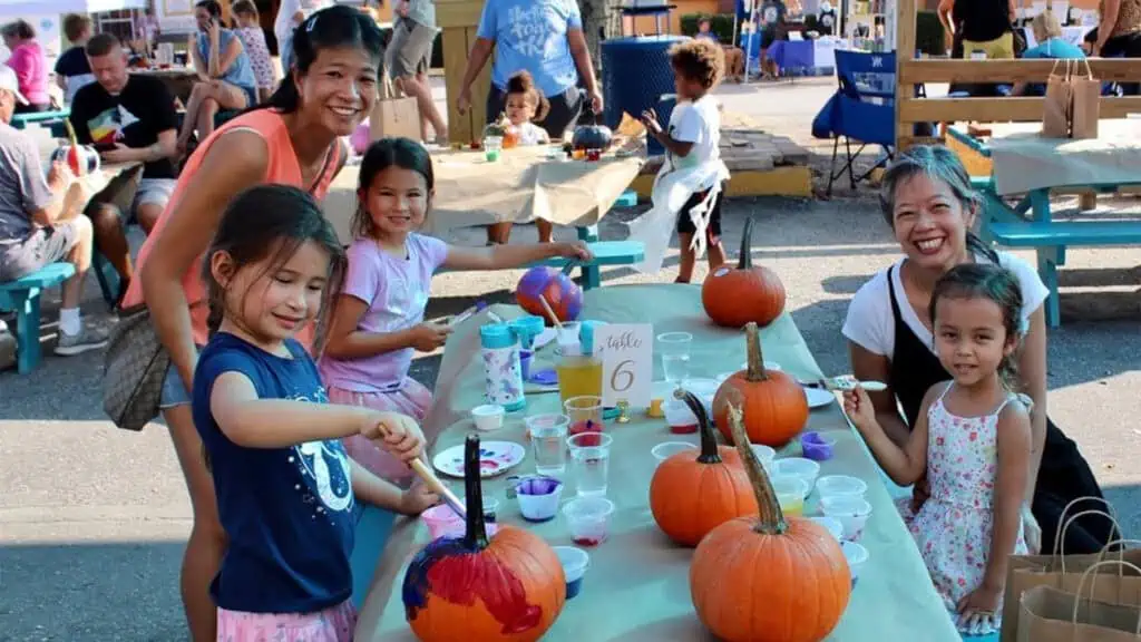 a group of people with pumpkins