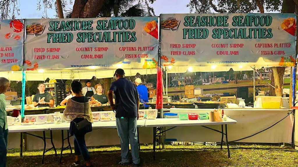 seafood vendors at a local food festival at sunset