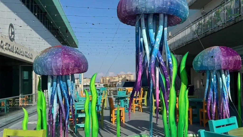 three large jellyfish lanterns outside of an aquarium