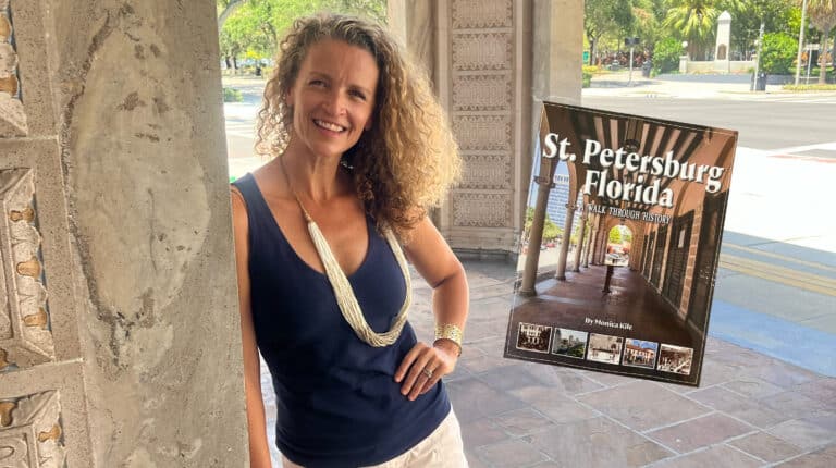 Photo of Monica Kile at the Open Air Post Office in St. Petersburg with inset photo of the cover of her book entitled St. Petersburg, A Walk Through History.