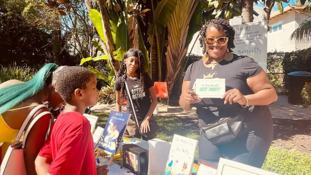 kids look at book at an outdoor festival 