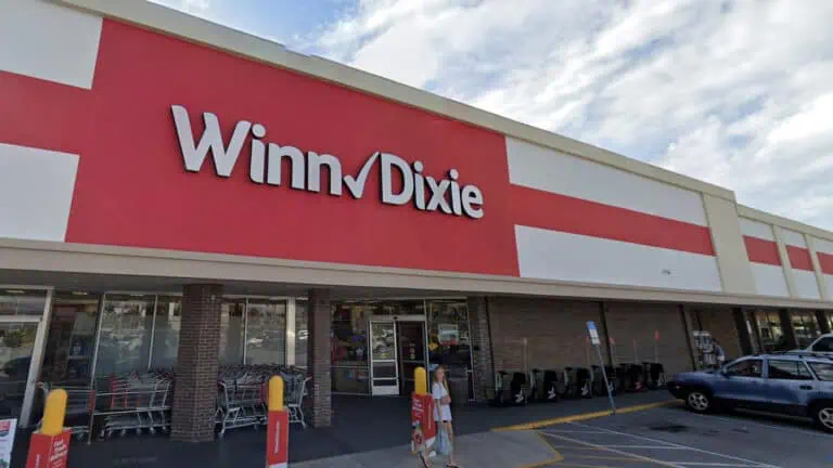 exterior of a grocery store with a red banner