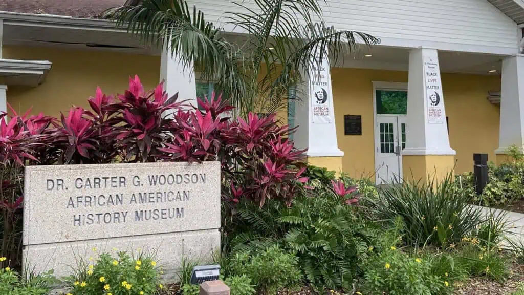 exterior of a museum with a stone plaque outside 