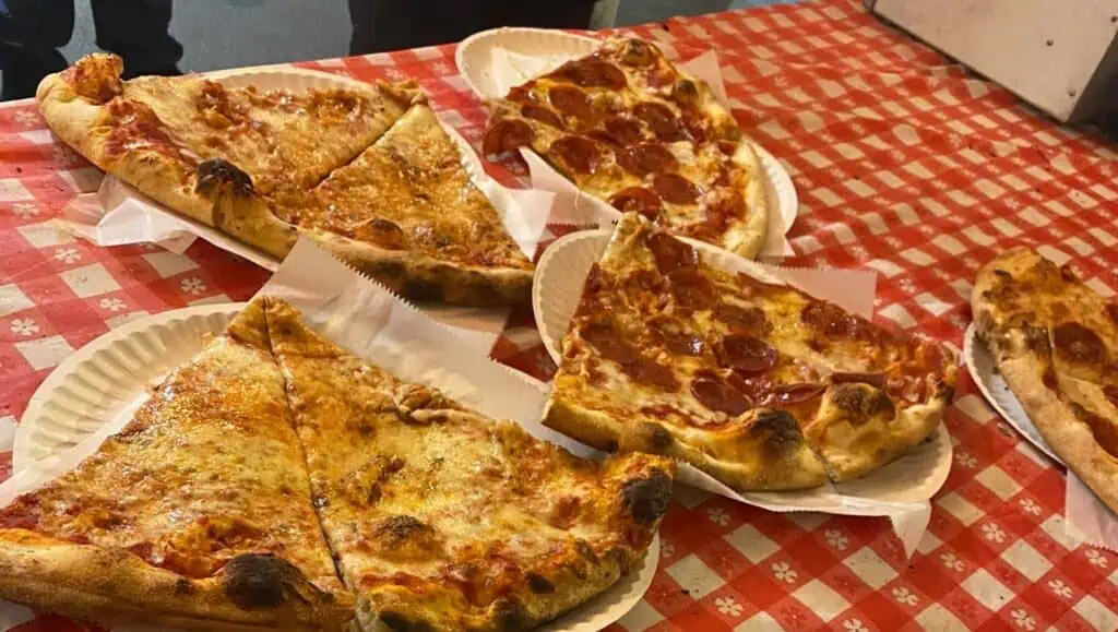 multiple slices of pizza on a table 