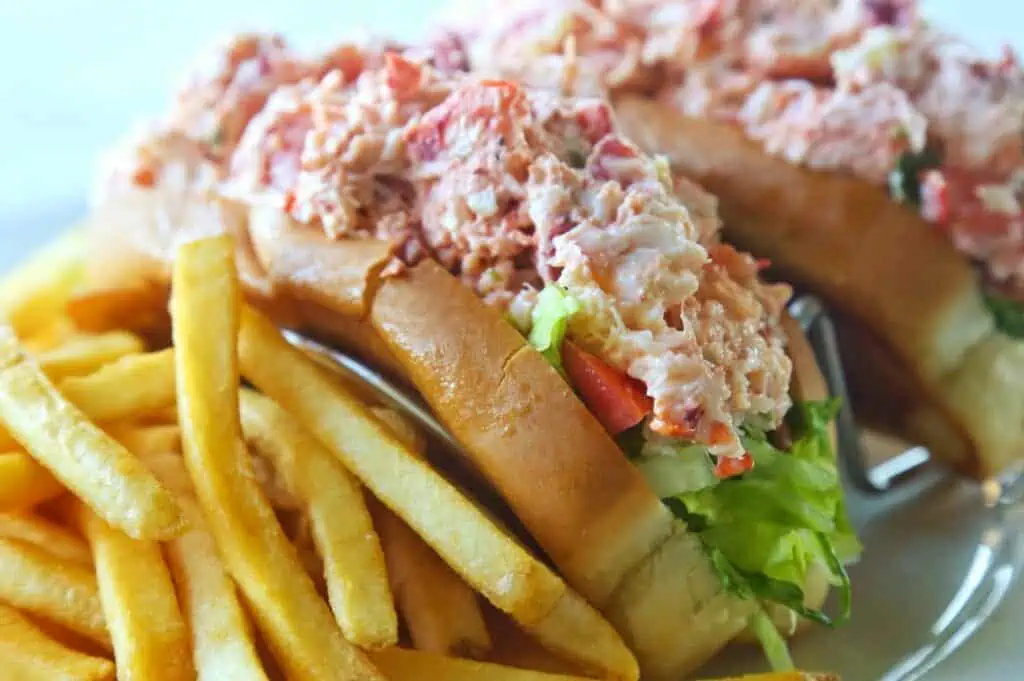 lobster roll on a plate with fries 