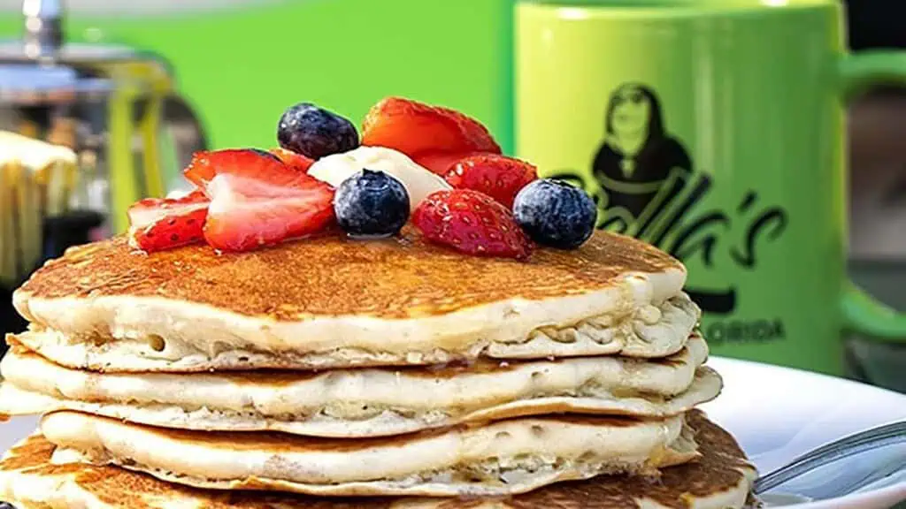 a stack of pancakes topped with fresh fruit 