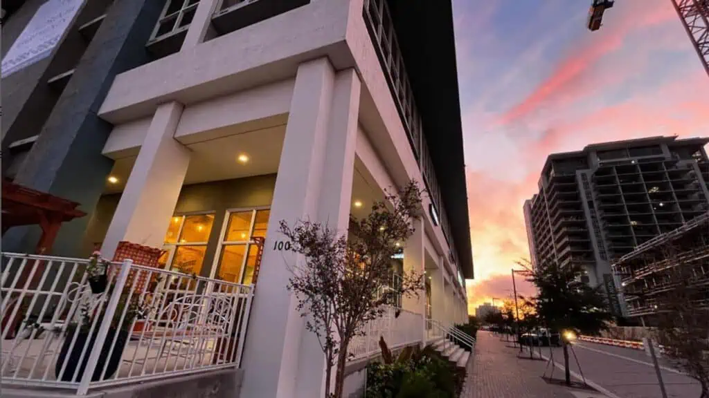 Exterior of a cafe with patio seating at sunrise