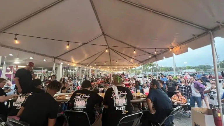 a group of people dining under a tent