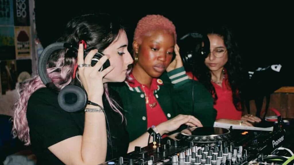 two people at a DJ booth during a concert