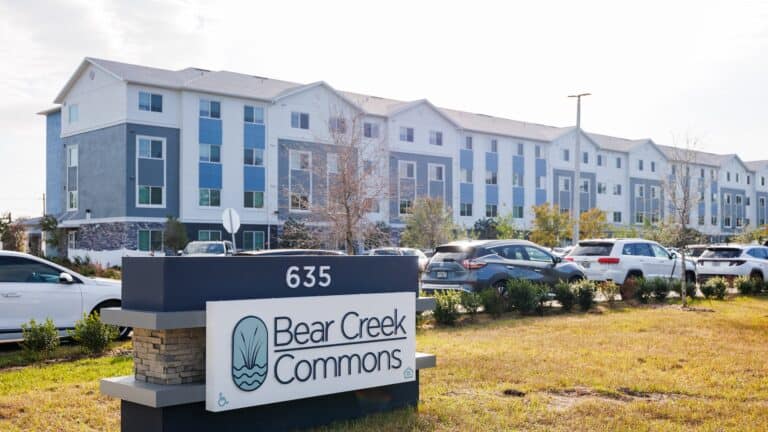 outside an new housing development with a sign reading "bear creek" on the outside