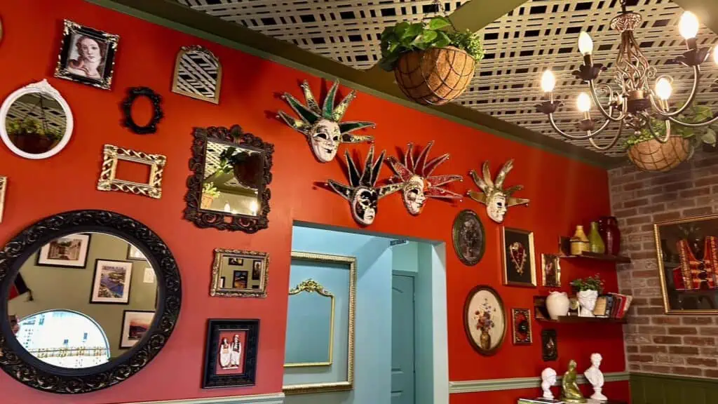 interior of a restaurant with red walls and decor on the walls