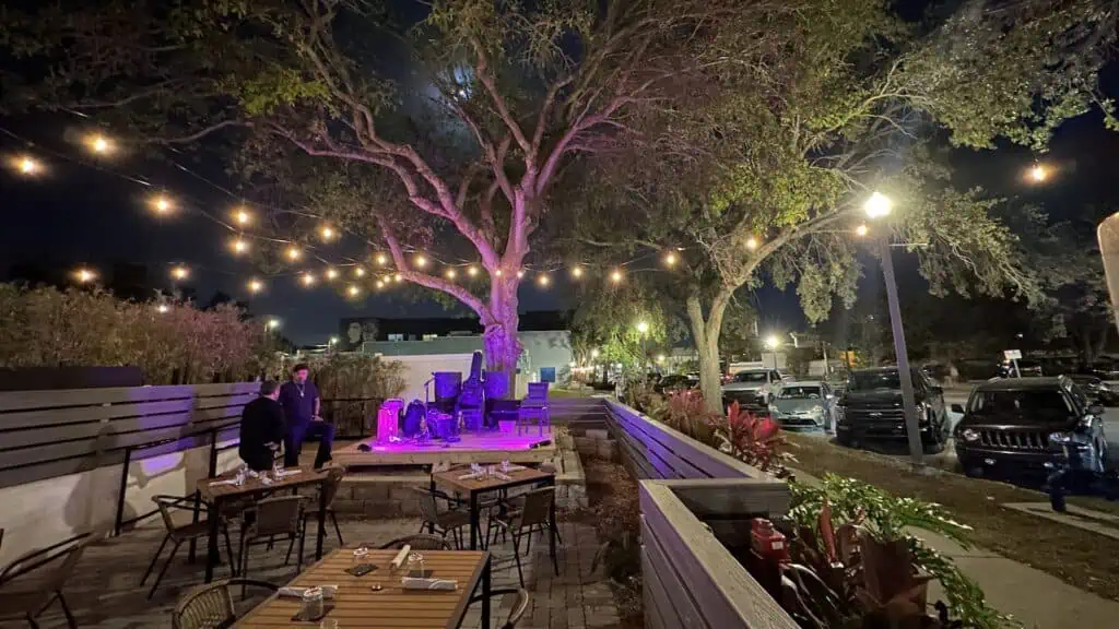 outdoor seating with a stage area at a restaurant