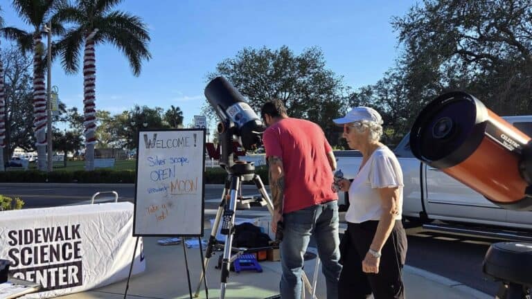 a telescope set up on a sidewalk