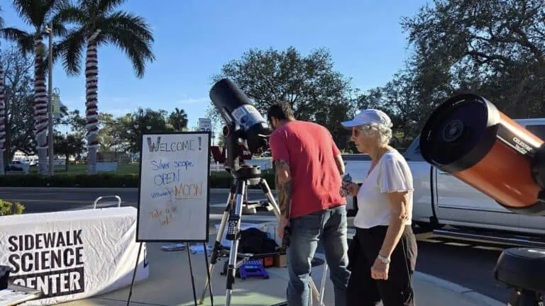 a telescope set up on a sidewalk