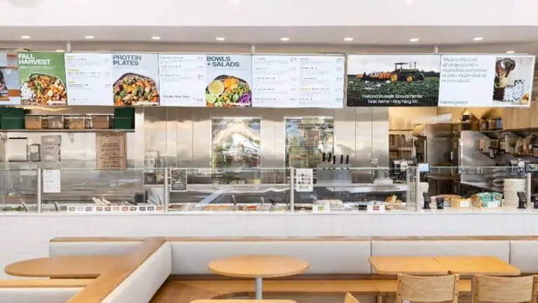 interior of a counter service restaurant with a full menu on illuminated digital boards