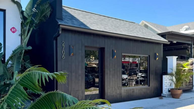 small black hut with glass door. The sign on the window reads "Slim Charmer"