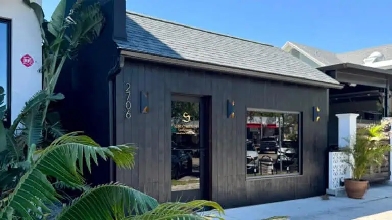 small black hut with glass door. The sign on the window reads "Slim Charmer"