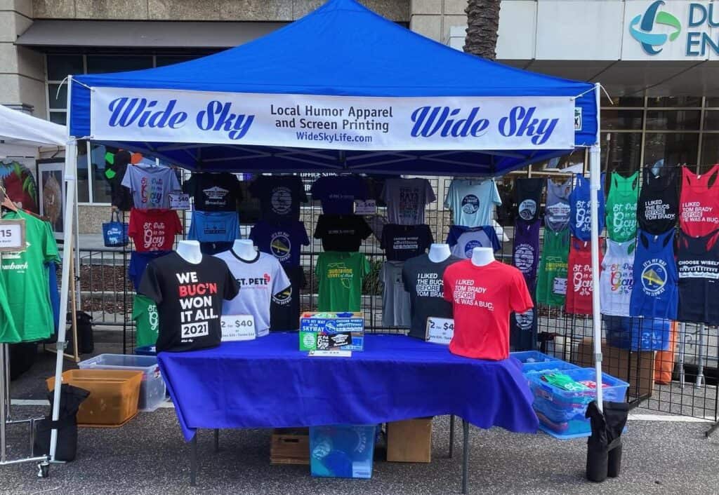 blue tent selling T-shirts. 