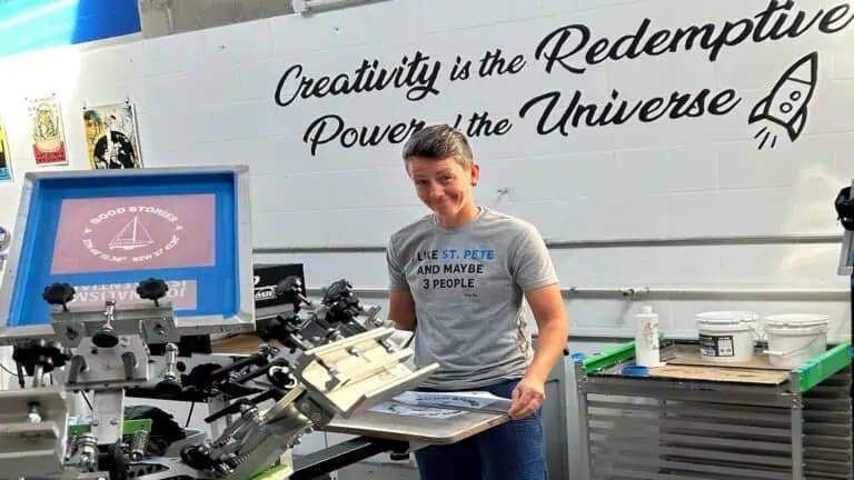 person standing in screen printing workshop