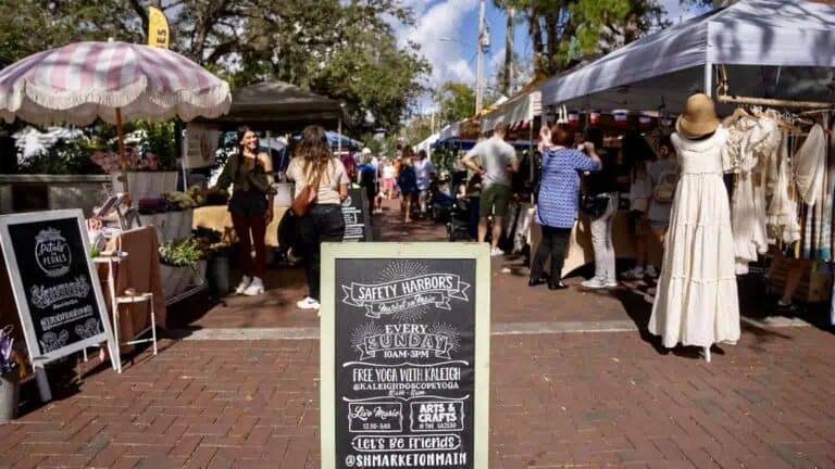 a sprawling market in Safety Harbor on a brick street with vendor tents on either side of the road