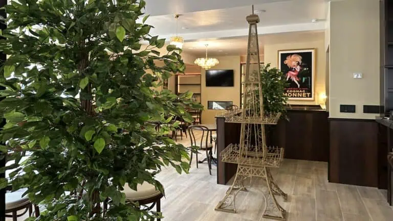 interior of a restaurant with a tall metal Eiffel Tower statue at the center