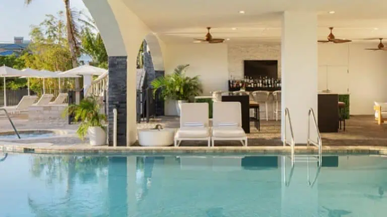 pool at a hotel with lounge chairs arranged around the pool