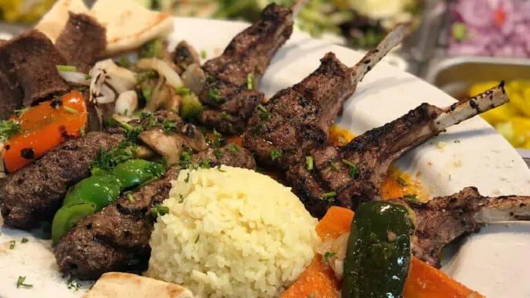 a plate of meat and veggies presented on a large table