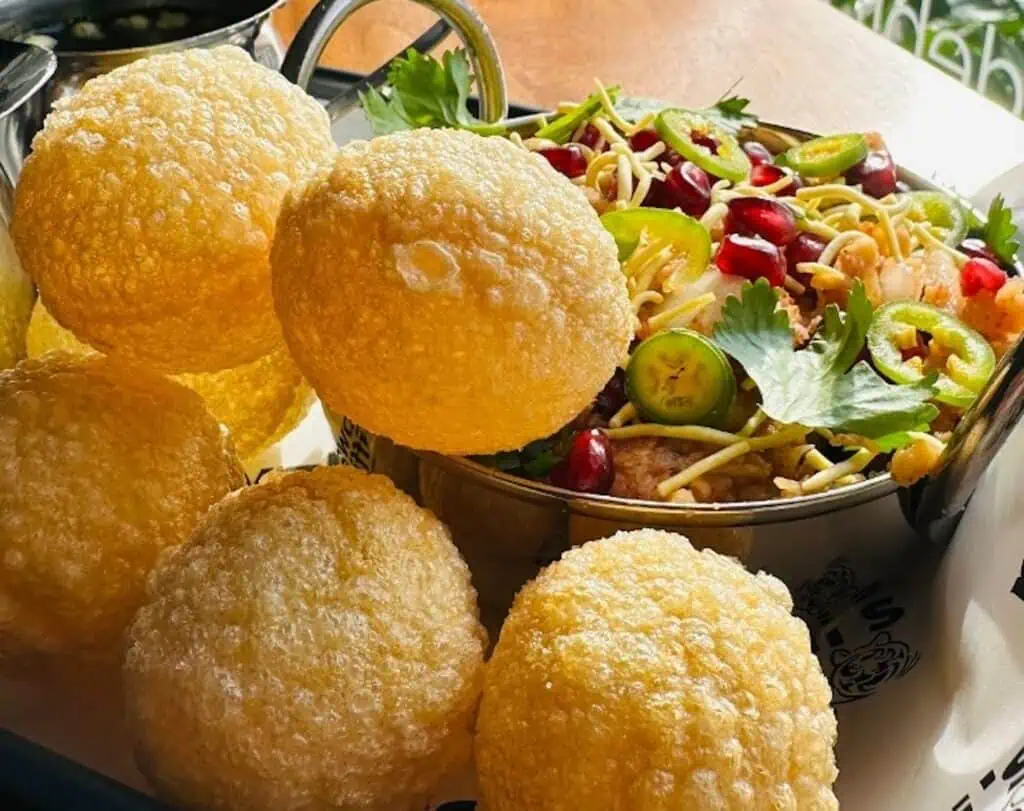 puffed rice balls on a plate with a side of veggies