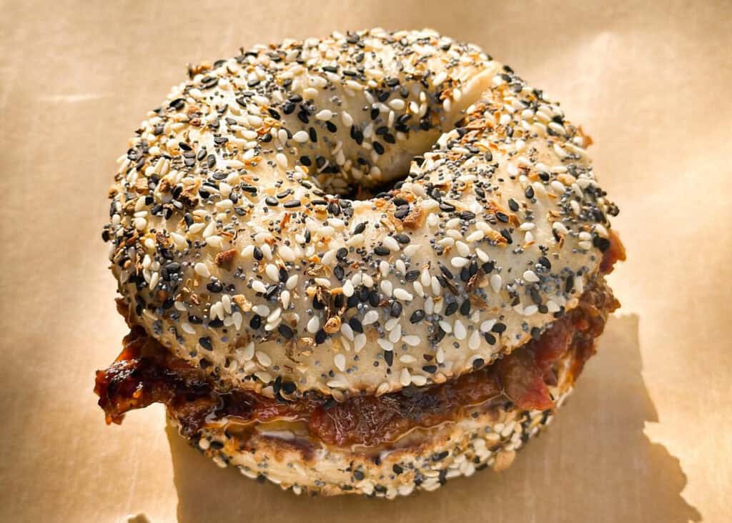 A sesame and poppy seed-covered everything bagel stuffed with a savory filling.