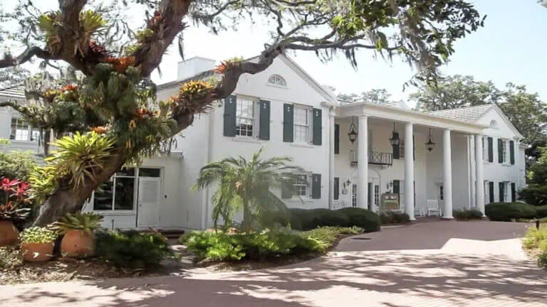 white building with a tree to the left side