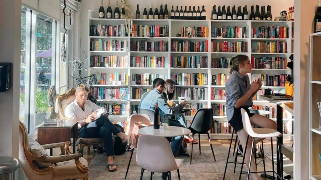 interior of a book and wine shop with people reading book. It's one of the most beautiful bookstores in the city. 