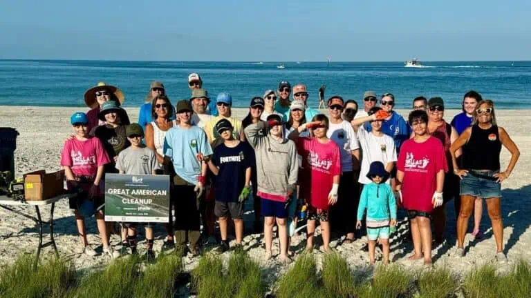 Keep Pinellas Beautiful volunteers pose for a photo on the beach during a big county-wide cleanup event