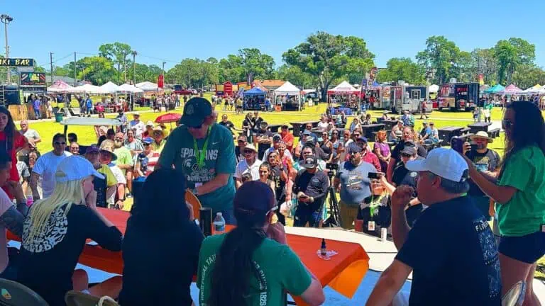 a group of people compete in an eating competition on stage
