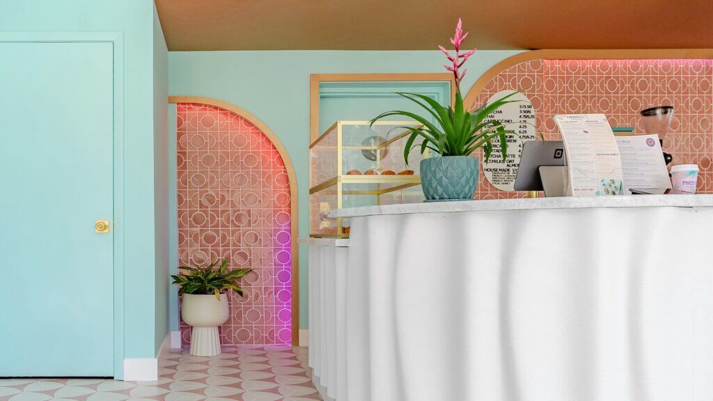 a bright pink and blue cafe inside of the SkyBeach resort. A 3D printed coffee bar is the focal point of the image.