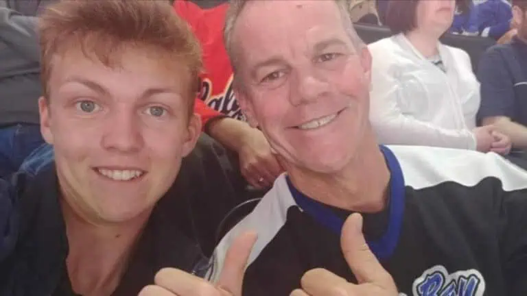 A father and son posing together