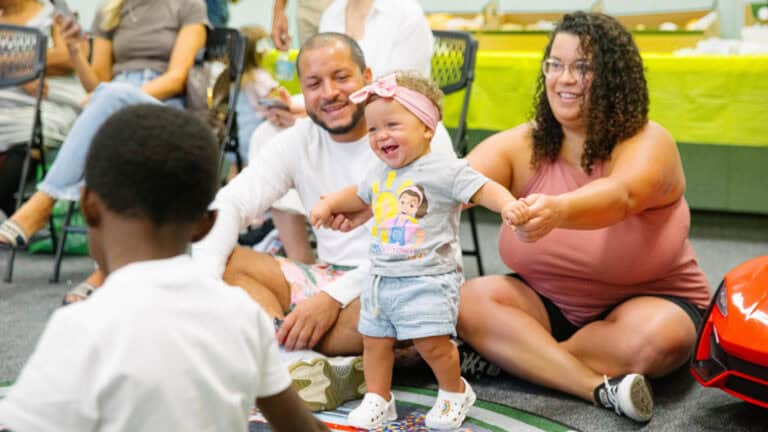 Adults playing with a baby