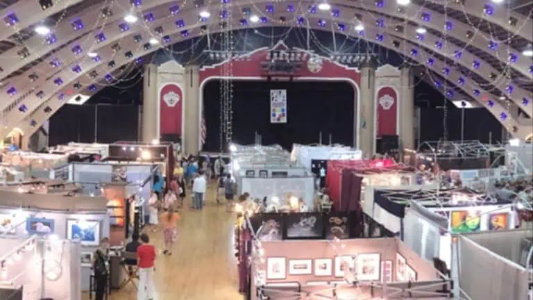 Interior of a coliseum hosting a sprawling art show