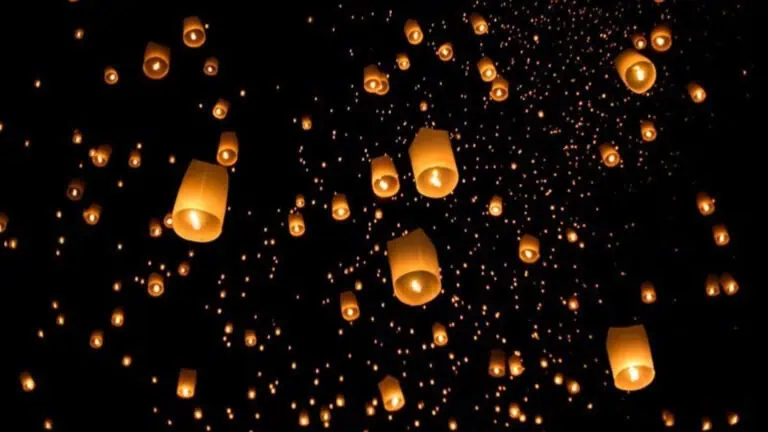 Glowing lanterns floating in the night sky